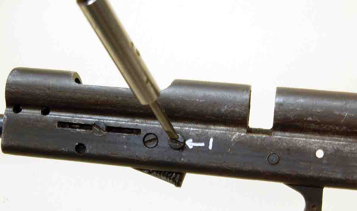 The screw marked “1” is removed to release the cartridge lifter assembly (tube magazine gun) and the trigger sear assembly.